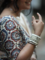 Ivory Modal Silk Ajrakh Printed Saree with Traditional Floral Motifs, Heritage Border & Tassel Detailing